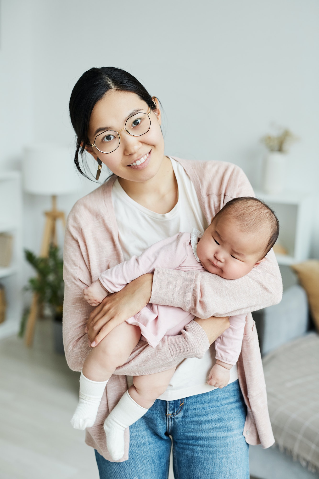 Asian woman holding her little child